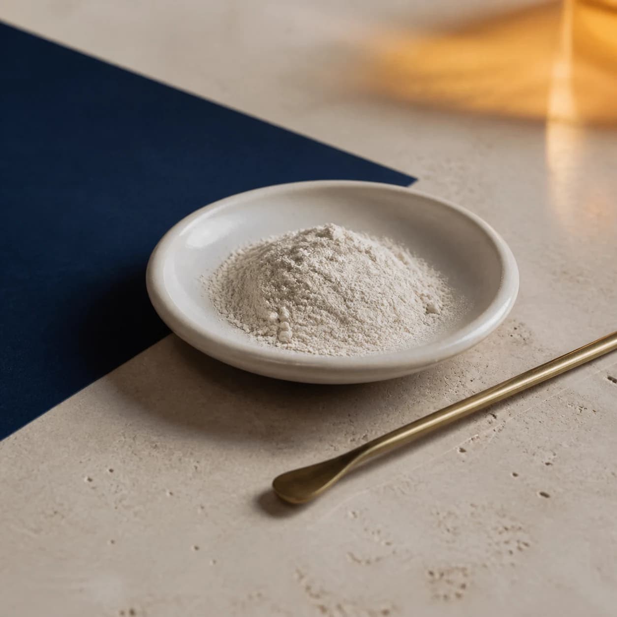 Concept photograph of fine magnesium bisglycinate powder in a shallow dish.